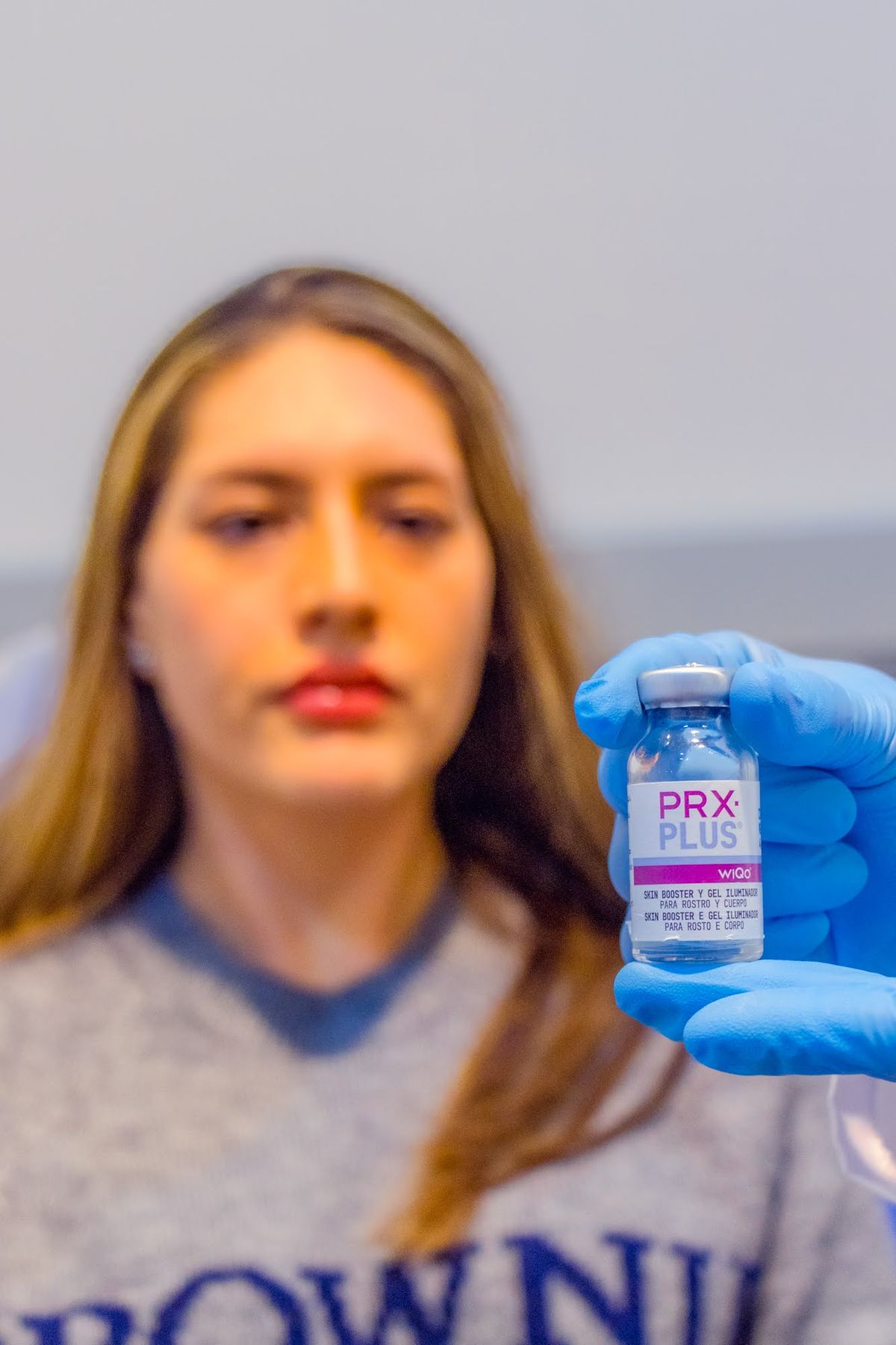 Vial de PRX PLUS sostenido por una especialista antes de la aplicación inyectable en Skin Plus Bogotá